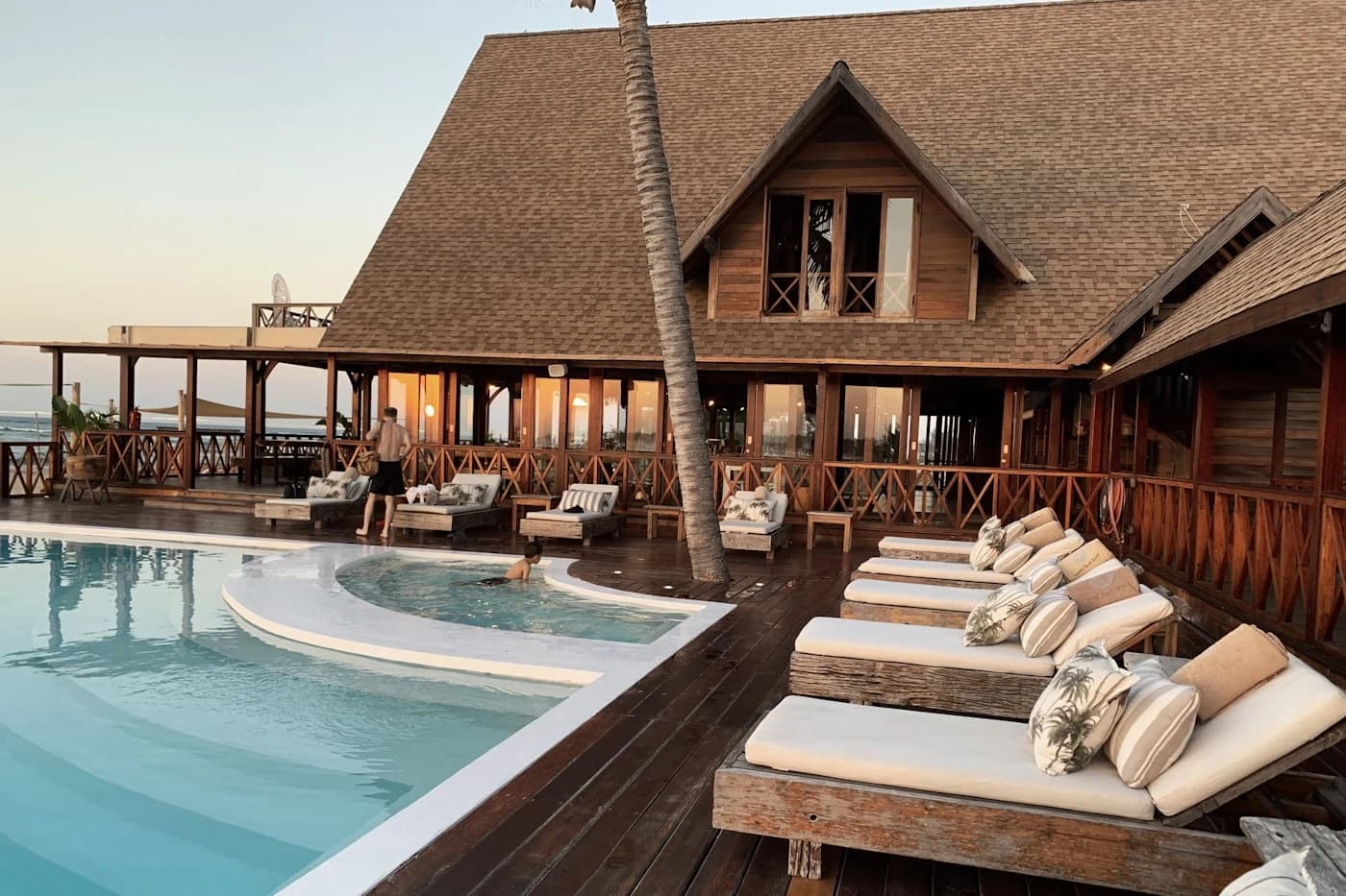 Luxury hotel resort with sunlit architecture, calm pool, and pristine daylight hospitality environment