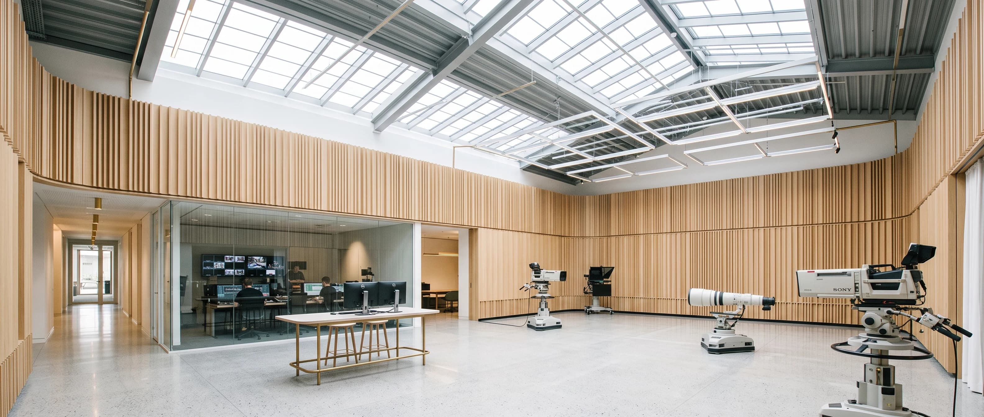 Bright sunlit studio production workspace and modern broadcast digital facility
