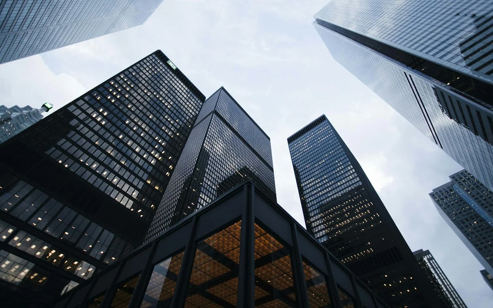 Ultra-modern commercial glass skyscraper bathed in bright sunny daylight with clean corporate architecture